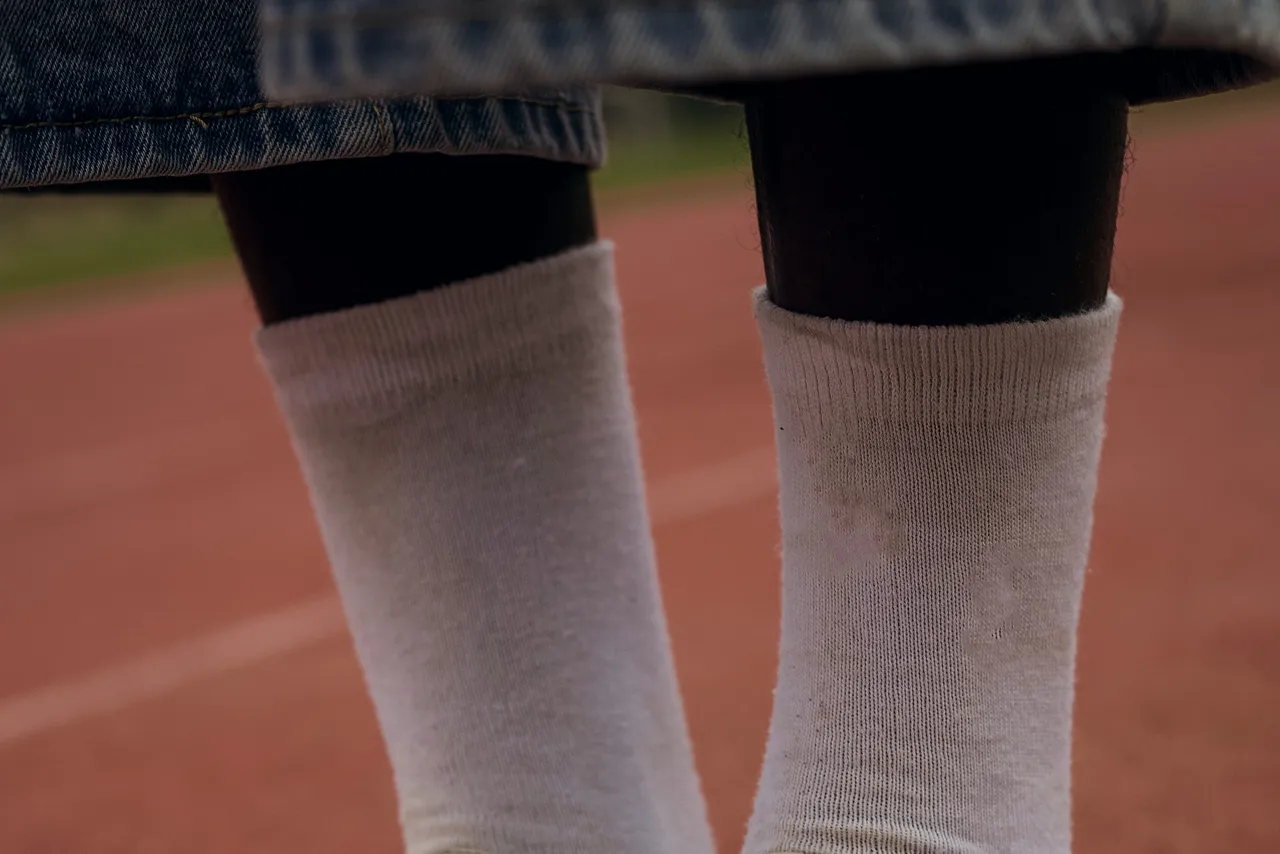 White crew socks pulled up above worn boots.